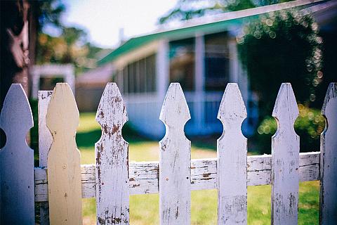 White Picket Fence with House in Background